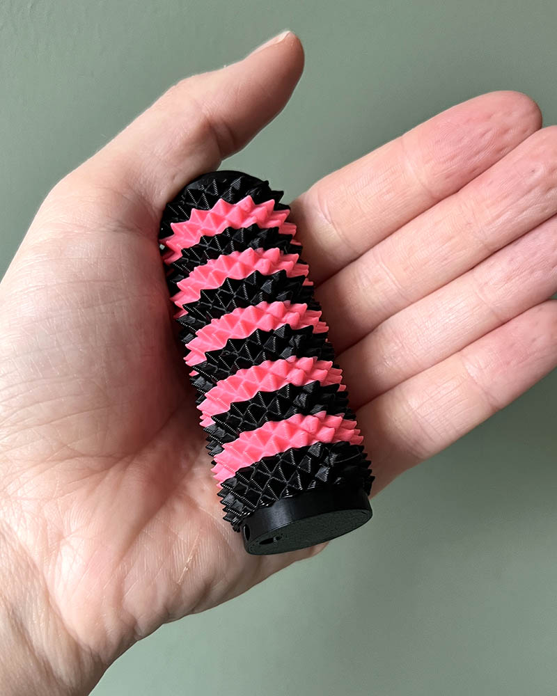 pink and black spiky stim toy high intensity sensory fidget toy for autism and anxiety