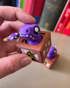Dino in a Crate Clicker Fidget Toy