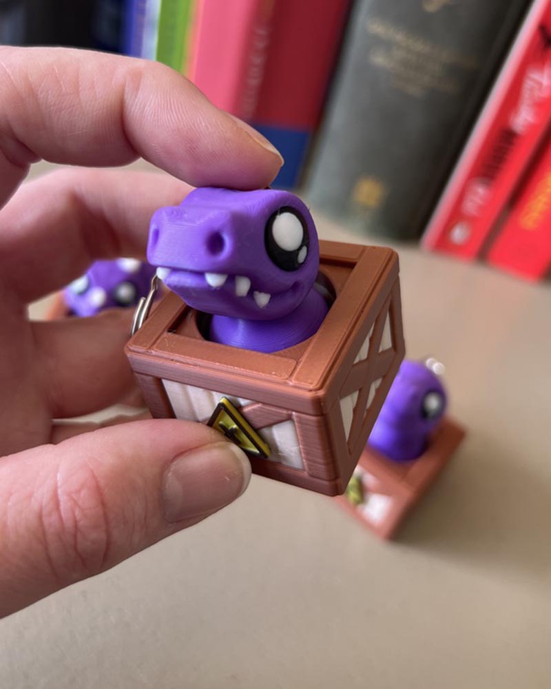 Dino in a Crate Clicker Fidget Toy