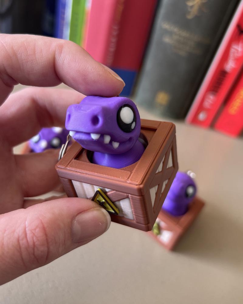 Dino in a Crate Clicker Fidget Toy